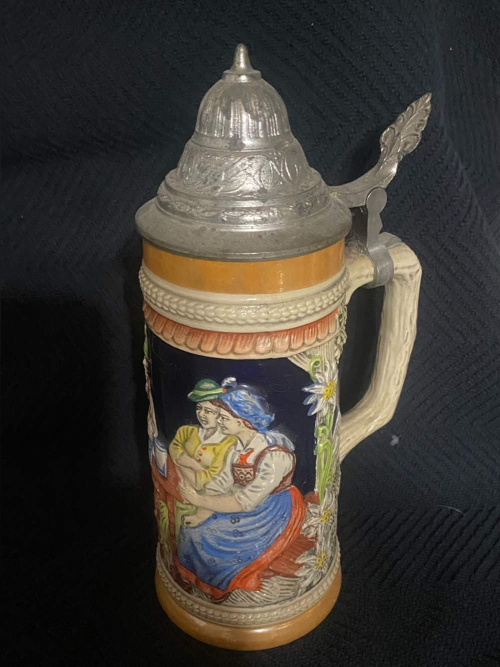 BEER STEIN - HANDARBEL IS WRITTEN ON THE BOTTOM. A BIT TARNISHED ON TOP